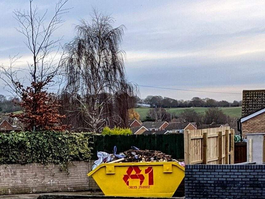 Yellow builders' skip on a UK street